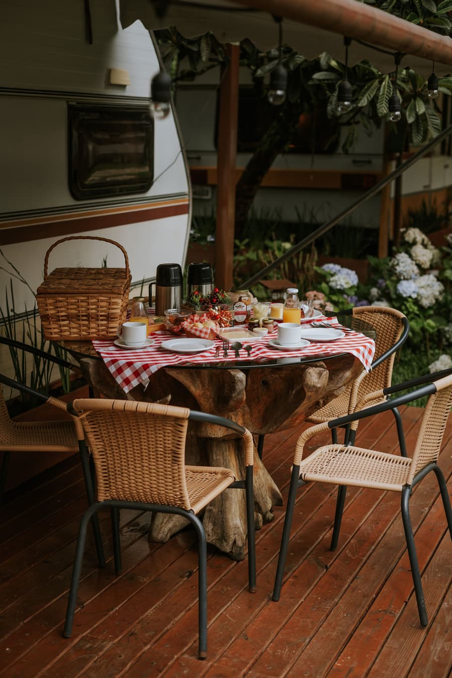 Breakfast laid out on a cottage veranda, wicker chairs