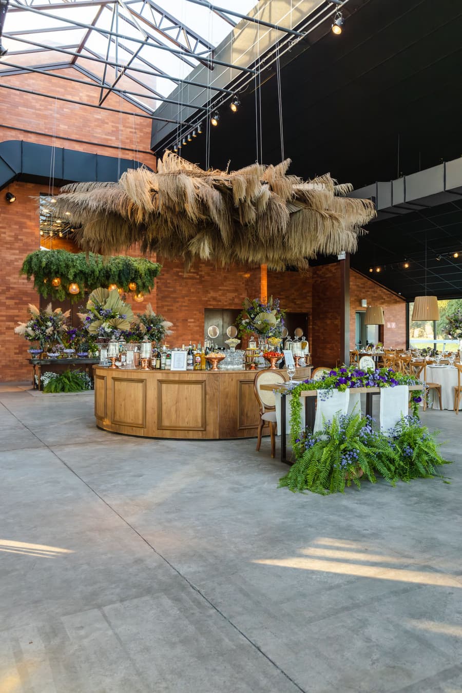 The grain store's brick wall and bar, pampas hanging from the glass roof